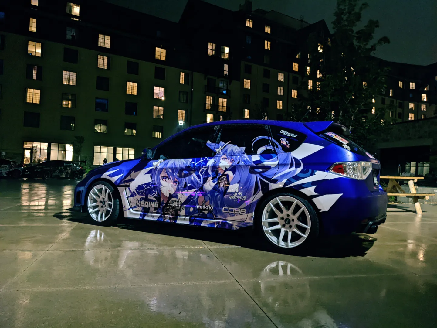 Itasha car with a blue wrap at night